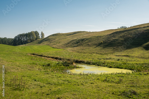 Autumn view on the meadow, hills and trees in Suwalski Landscape Park, Podlaskie, Poland photo