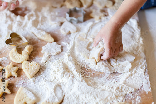 Bilde på lerret Child hands are cooking Christmas gingerbread cookies in home kitchen
