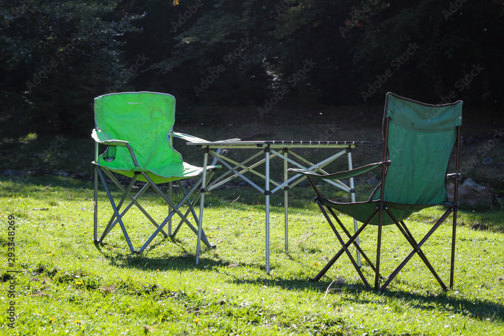 Picnic chairs and table. Holidays in the mountains. Traveling by car. Carpathian Mountains Picnic chairs and table. Holidays in the mountains. Traveling by car. Carpathian Mountains