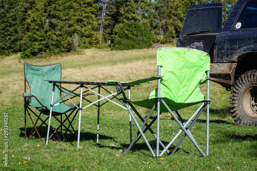 Picnic chairs and table. Holidays in the mountains. Traveling by car. Carpathian Mountains