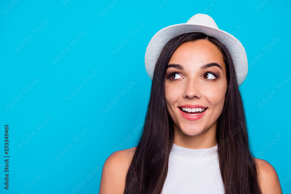 Closeup photo of pretty lady looking wondered to empty space wear nice white hat and tank-top isolated blue color background Closeup photo of pretty lady looking wondered to empty space wear nice white hat and tank-top isolated blue color background