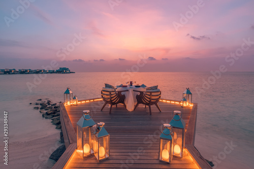 Fototapeta Naklejka Na Ścianę i Meble -  Romantic sunset over wooden table with seascape and skyline in the evening with sunset tone style