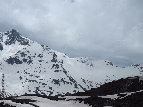 Beautiful view of the mountains in the area of Elbrus. Panorama overlooking the top of the mountain covered with snow