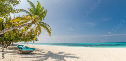 Tropical beach panorama as summer landscape with beach swing or hammock and white sand and calm sea for beach banner. Perfect beach scene vacation and summer holiday concept. Boost up color process © icemanphotos