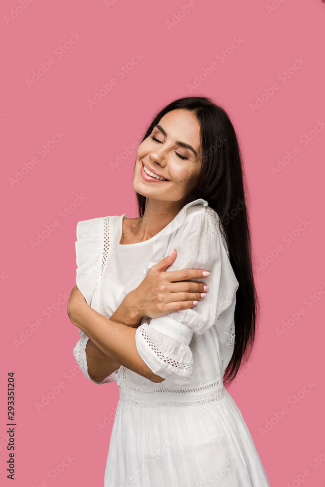 smiling woman in white dress touching body isolated on pink smiling woman in white dress touching body isolated on pink