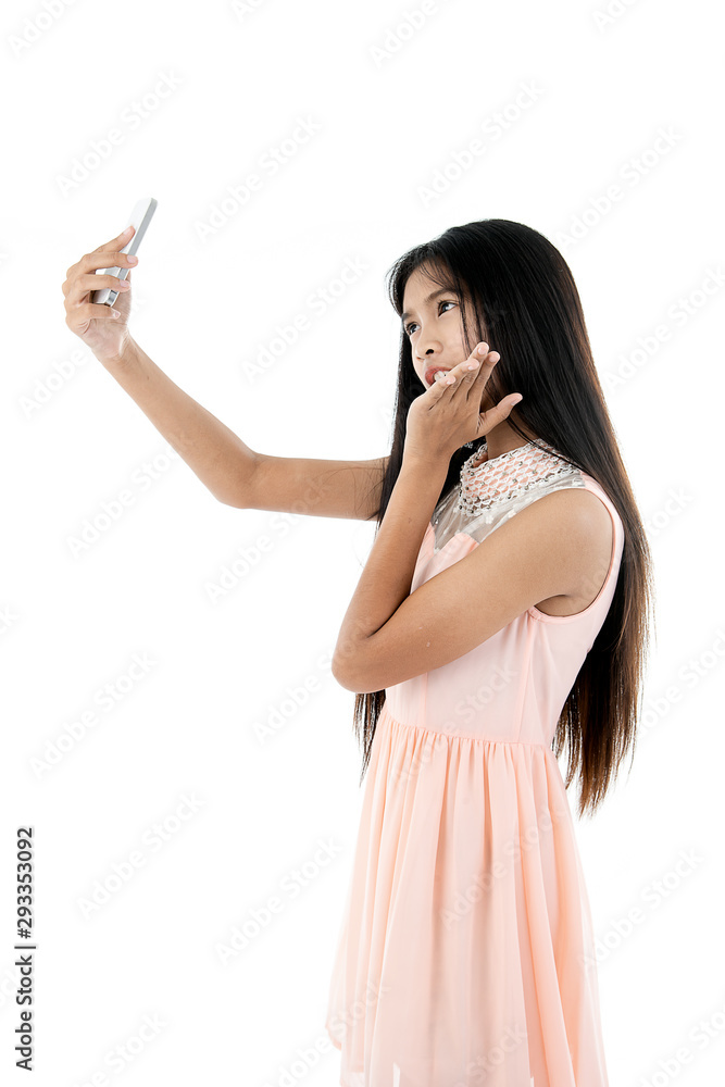 Cute Asian teenager using cellphone for selfie, isolated on white. Cute Asian teenager using cellphone for selfie, isolated on white.
