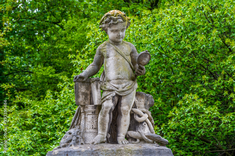 The sculpture of a boy looking at a mirror on the wall of Royal Palace in Brussels The sculpture of a boy looking at a mirror on the wall of Royal Palace in Brussels