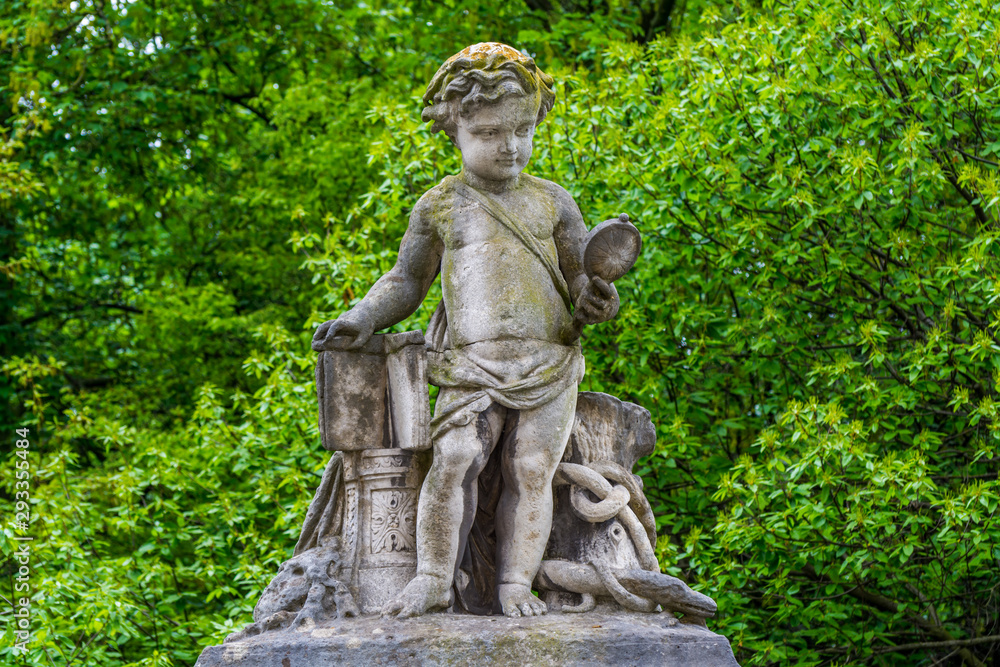 The sculpture of a boy looking at a mirror on the wall of Royal Palace in Brussels