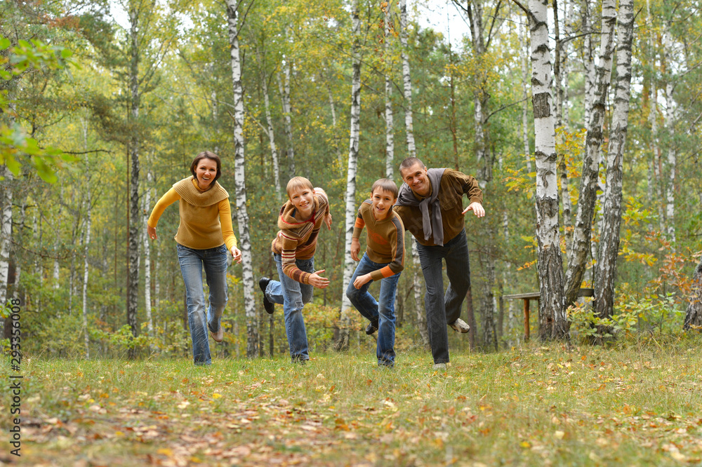 Portrait of family of four having fun in autumn forest Portrait of family of four having fun in autumn forest