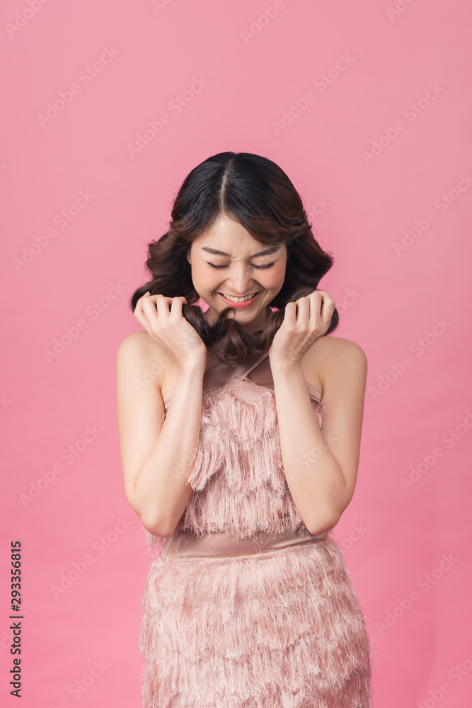Asia beautiful woman wear pink dress. Standing in front of a pink background. Asia beautiful woman wear pink dress. Standing in front of a pink background.