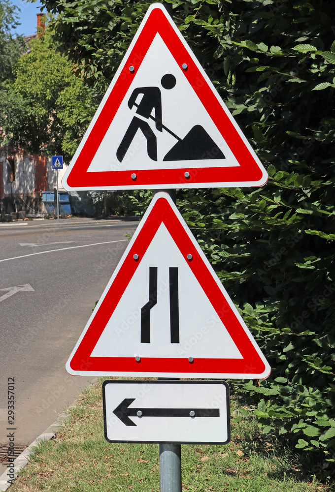 Road works and other traffic signs next to the road Road works and other traffic signs next to the road