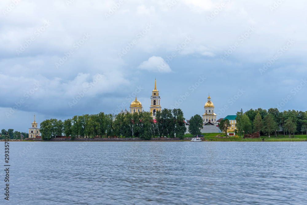 Obraz premium Picturesque view of Nilo Stolobensky Monastery on Lake Seliger, Tver region, Russia. Panoramic view of Nilo Stolobensky Monastery, Tver region, Russia.