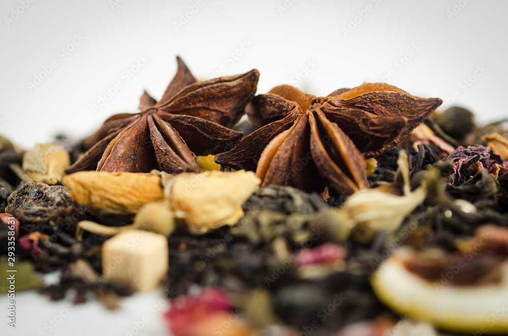 Anise stars on a background of black tea with a yellow rose Anise stars on a background of black tea with a yellow rose