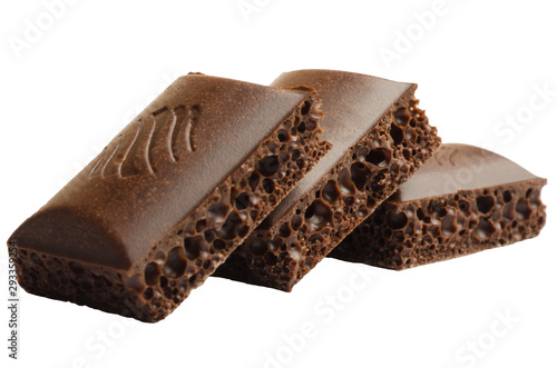 Three pieces of porous chocolate on a white background