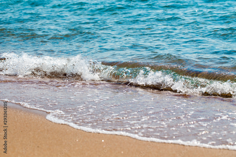 sandy beach and blue sea wave. Beautiful natural background. Tourism and travel. sandy beach and blue sea wave. Beautiful natural background. Tourism and travel.