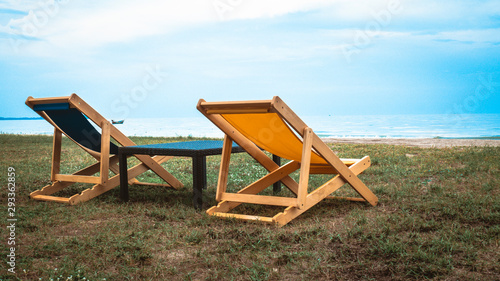 Empty deck chair .Beautiful color chairs on the beach. Blue sky relax happy vacation holiday.