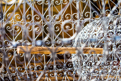 silver iron ornamentic bird cage close up photo