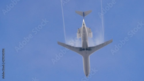 Small passenger jet passes directly over camera in 180fps slow motion, clear day