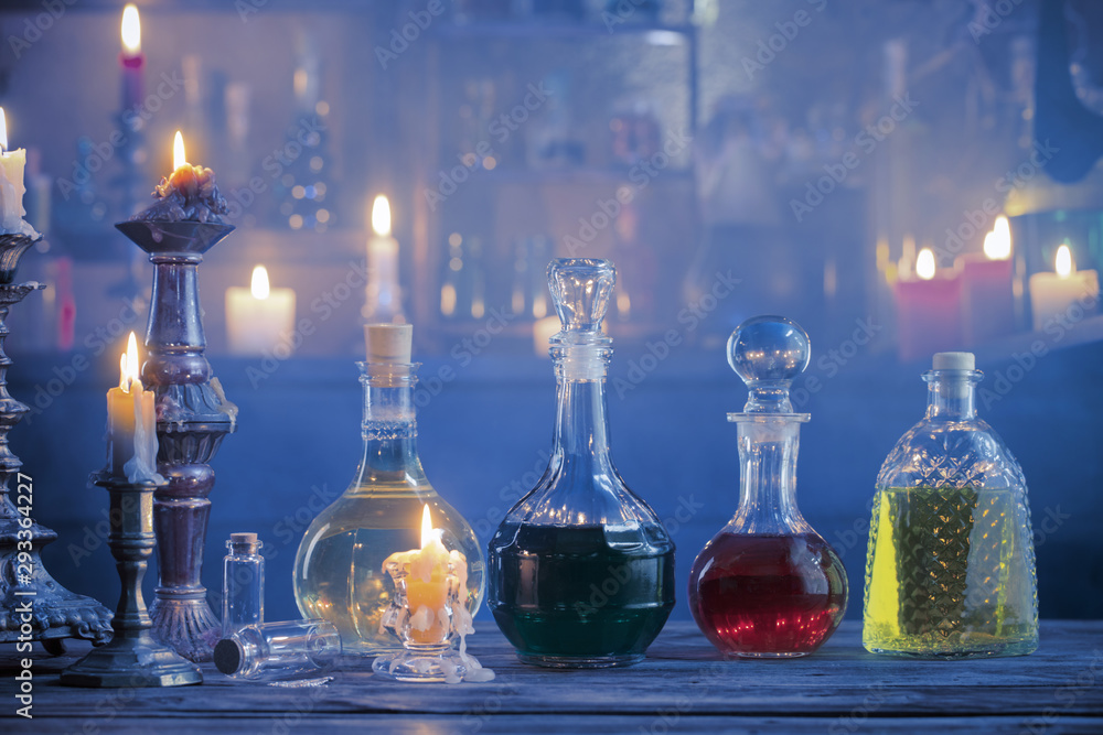 magic potions in bottles on wooden background - obrazy, fototapety, plakaty 