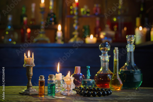 magic potions in bottles on wooden table