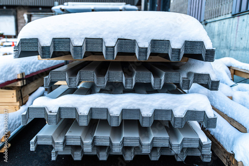 Corrugated roofing metal sheets stored outside in winter