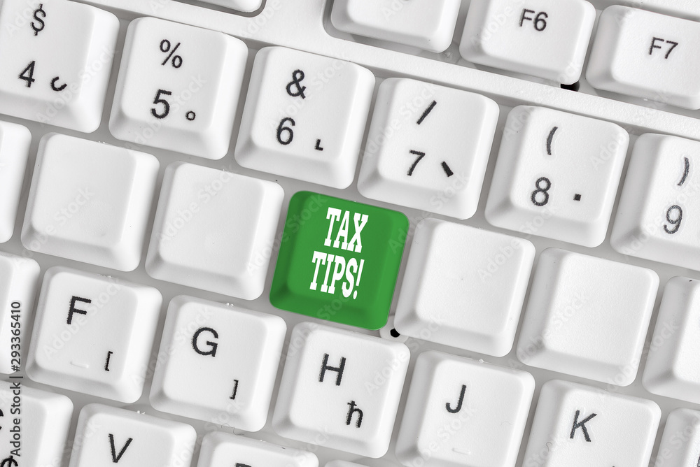 Handwriting text writing Tax Tips. Conceptual photo compulsory contribution to state revenue levied by government White pc keyboard with empty note paper above white background key copy space Handwriting text writing Tax Tips. Conceptual photo compulsory contribution to state revenue levied by government White pc keyboard with empty note paper above white background key copy space