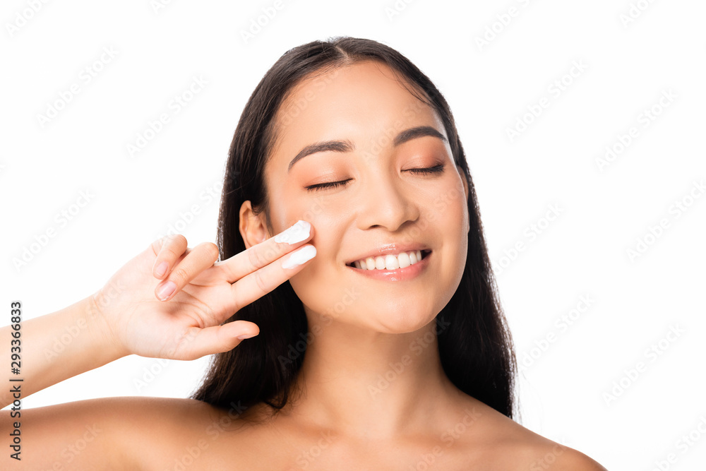 naked beautiful asian woman with cosmetic cream on fingers and closed eyes isolated on white naked beautiful asian woman with cosmetic cream on fingers and closed eyes isolated on white
