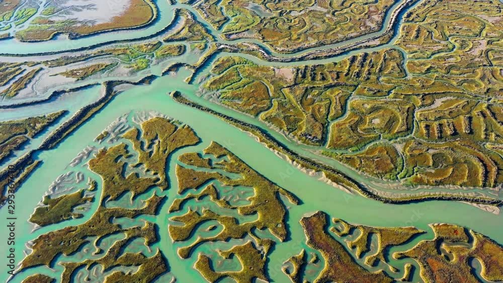 Flying over abstract salty expanses under the sunset, along the coastline overlooking a beautiful landscape full of green colors - aerial view with a drone - landscape and graphic concept Flying over abstract salty expanses under the sunset, along the coastline overlooking a beautiful landscape full of green colors - aerial view with a drone - landscape and graphic concept