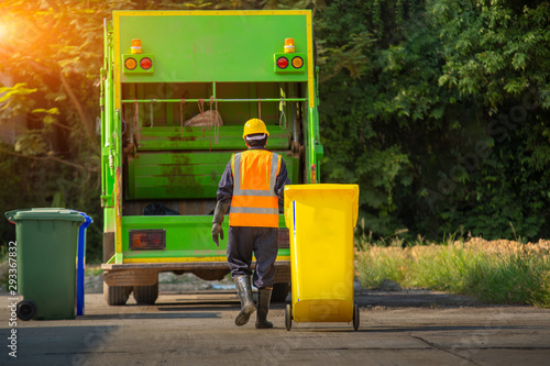 Recyclable garbage truck and the keeper  in the village. photo