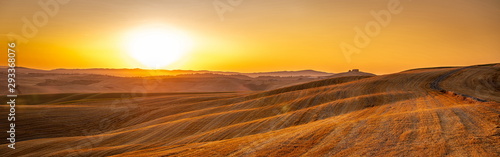 Beautiful Tuscany panorama of Crete Senesi golden sunrise with farm house and rolling hills photo