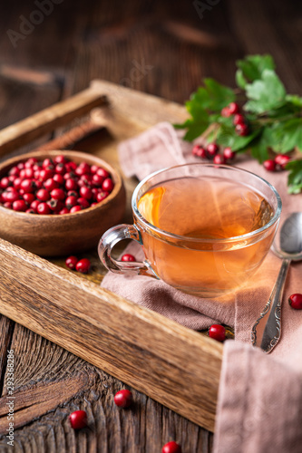 A cup of hot hawthorn tea made from freshly picked berries, herbal medicine for heart health