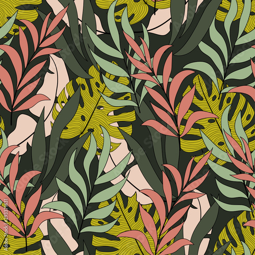 Tropical seamless pattern with bright yellow and pink leaves and plants on a green background. Colorful stylish floral. Modern abstract design for fabric, paper, interior decor.