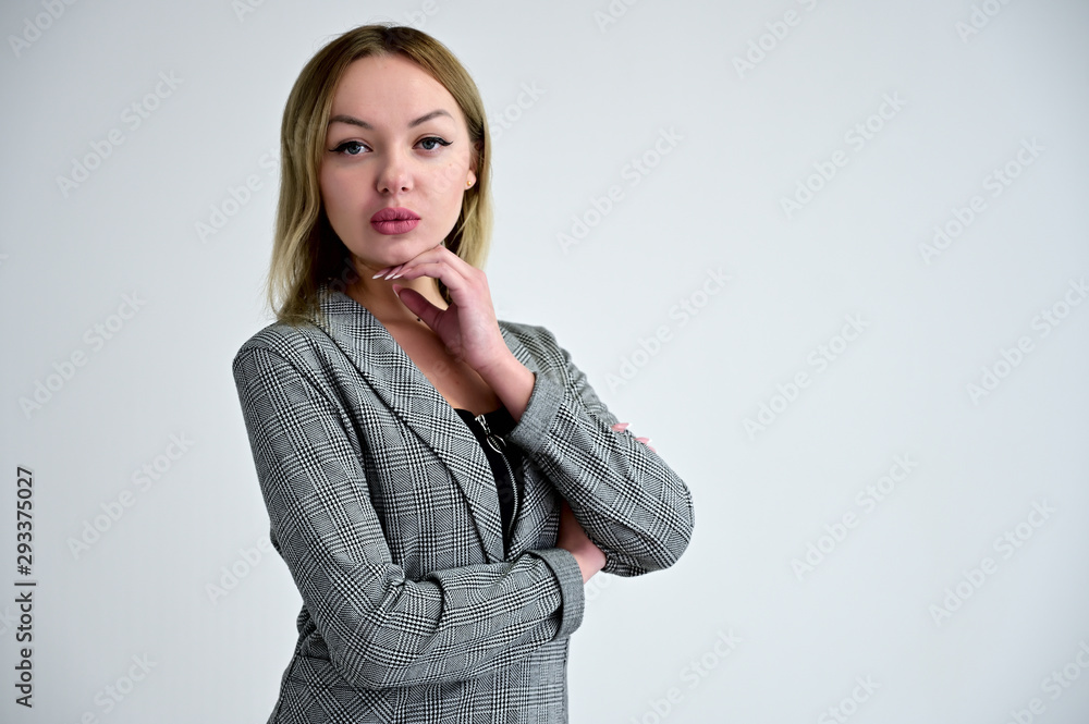 Portrait of a woman with full lips in a gray business jacket on a white background. Portrait of a woman with full lips in a gray business jacket on a white background.