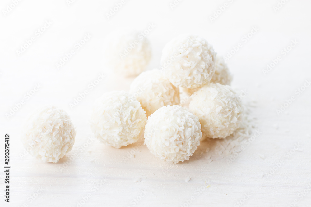 coconut candy in coconut flakes on a white background