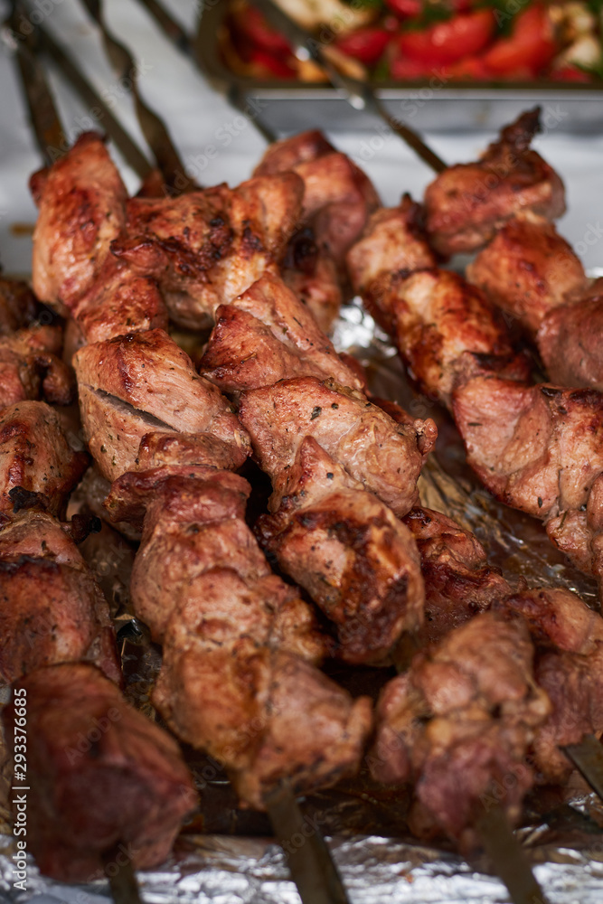 barbecue meat on skewers. grilled meat on open grill. street food