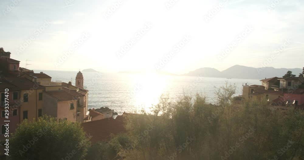 Village of Tellaro di Lerici illuminated by the light of the sunset. The sun is reflected in the sea of the Gulf of La Spezia. Village of Tellaro di Lerici illuminated by the light of the sunset. The sun is reflected in the sea of the Gulf of La Spezia.