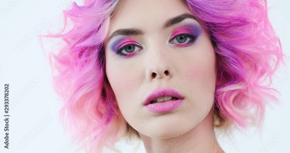 Closeup portrait of a fashion model with bright purple hair. Stylish woman with fashion hairstyle. Beauty face with a pink makeup. Fashionable girl. Art concept. 4k footage. Real time. Closeup portrait of a fashion model with bright purple hair. Stylish woman with fashion hairstyle. Beauty face with a pink makeup. Fashionable girl. Art concept. 4k footage. Real time.