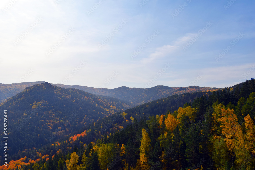 Reserve in the Krasnoyarsk region. Beautiful Siberian nature. Autumn forest. Panoramic view of the high mountains. Fascinating landscape.
