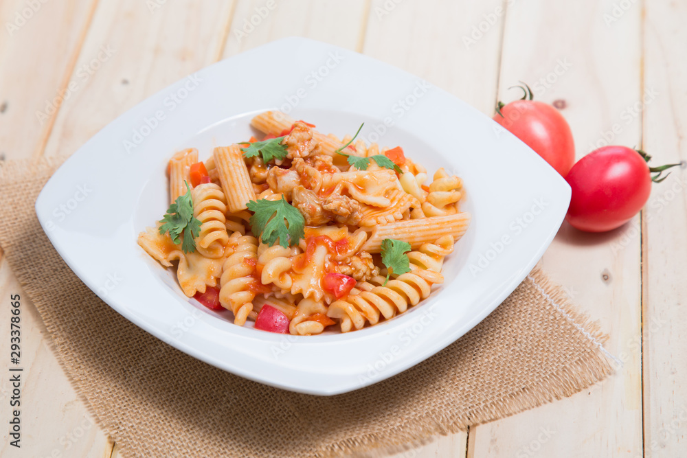 Spaghetti pasta with and tomato sauce on wood background Spaghetti pasta with and tomato sauce on wood background