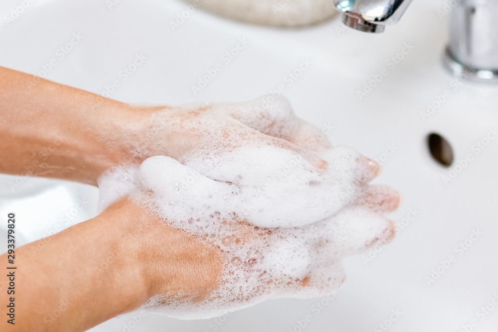 Fototapeta premium Hygiene concept. Washing hands with soap under the faucet with water