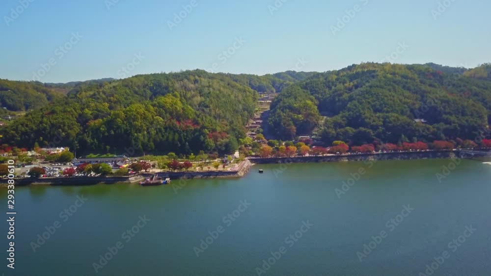 Aerial video of Wolyeonggyo bridge is located in the midst of Nakdong river in the morning during Autumn season at Andong city, South Korea. Aerial video of Wolyeonggyo bridge is located in the midst of Nakdong river in the morning during Autumn season at Andong city, South Korea.