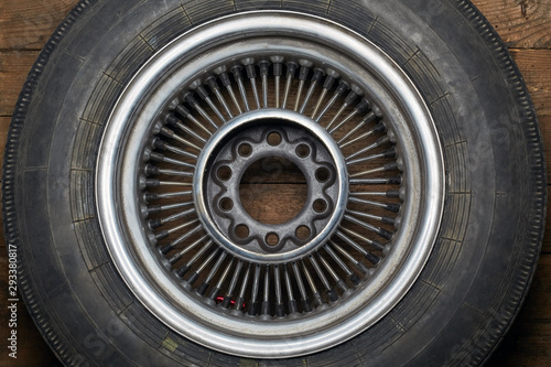 old car wheel on spokes with dust and dirt, which is suitable for retro, tuned cars or motorcycles