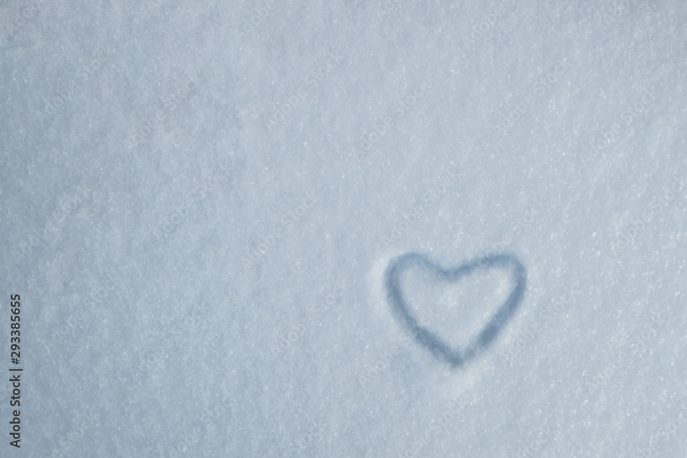 Drawing of heart on the background of fresh snow texture in blue tone. Merry Christmas or Valentine's Day Concept. Copy space, high resolution product Drawing of heart on the background of fresh snow texture in blue tone. Merry Christmas or Valentine's Day Concept. Copy space, high resolution product