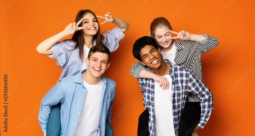 Excited teen guys giving piggyback ride to girls Excited teen guys giving piggyback ride to girls