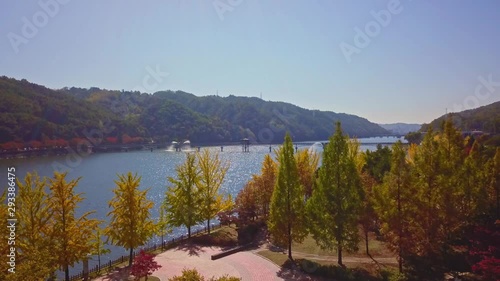 Aerial video of Wolyeonggyo bridge is located in the midst of Nakdong river in the morning during Autumn season at Andong city, South Korea. photo