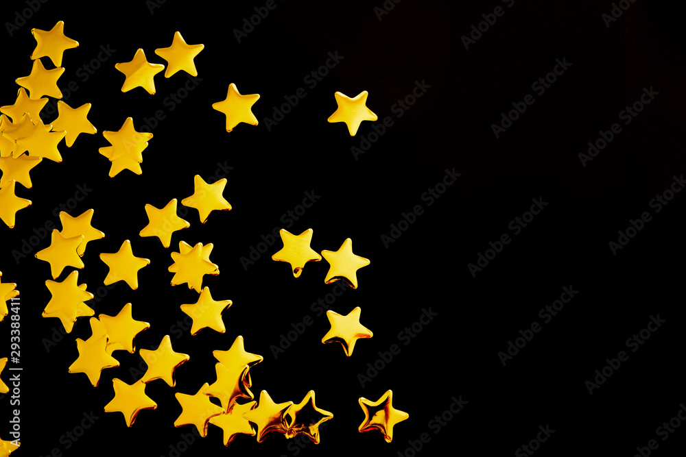Golden decorative stars on black background..Abstract backdrop. Festive concept. Golden decorative stars on black background..Abstract backdrop. Festive concept.