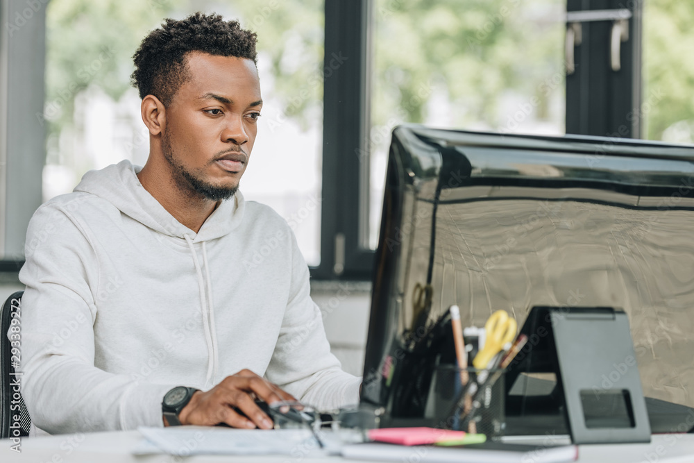 young african american programmer working on computer in office young african american programmer working on computer in office