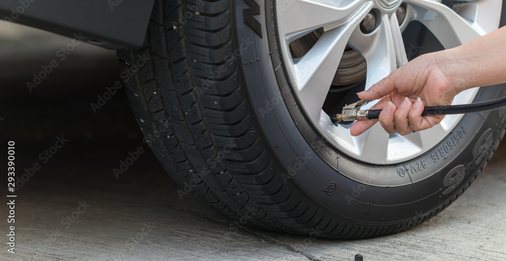 Inflating the tires and checking air pressure in service station.