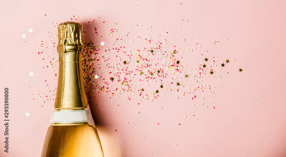 Flat lay of Celebration. Champagne bottle with sprinkles on pink background. - obrazy, fototapety, plakaty 