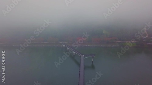 Aerial video of Wolyeonggyo bridge is located in the midst of Nakdong river in the morning during Autumn season at Andong city, South Korea. photo